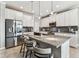 Bright kitchen featuring granite counters, stainless appliances, and an island with seating at 7537 Pool Compass Loop, Wesley Chapel, FL 33545