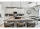 Spacious kitchen featuring a granite island, pendant lighting, and a breakfast bar with seating at 7537 Pool Compass Loop, Wesley Chapel, FL 33545