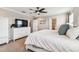 Comfortable main bedroom with a ceiling fan, white furniture, and ensuite bathroom access at 7537 Pool Compass Loop, Wesley Chapel, FL 33545