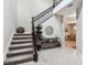 Elegant staircase featuring a wrought iron banister, plush carpet, and stylish decor at 7537 Pool Compass Loop, Wesley Chapel, FL 33545