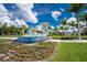Community entrance sign with fountain and tropical landscaping at 9982 Beachwalk Dr, Englewood, FL 34223