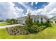 Charming single-story home featuring a manicured lawn and a well-maintained exterior at 9982 Beachwalk Dr, Englewood, FL 34223