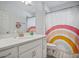 Bathroom with a single vanity, white cabinets and a rainbow shower curtain at 1352 Sunset Preserve Way, Port Charlotte, FL 33953