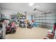 Attached garage with storage shelving and space for vehicles at 1352 Sunset Preserve Way, Port Charlotte, FL 33953