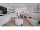 Spacious living area with hardwood floors and an open layout to dining and kitchen areas at 1352 Sunset Preserve Way, Port Charlotte, FL 33953