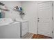 Bright laundry room with washer, dryer, and storage at 1352 Sunset Preserve Way, Port Charlotte, FL 33953