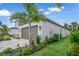 Single-story home with a brown garage door, landscaping, and a brick paver driveway at 1352 Sunset Preserve Way, Port Charlotte, FL 33953