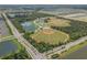 Aerial view of a community with baseball fields and lakes at 1352 Sunset Preserve Way, Port Charlotte, FL 33953