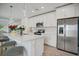 Modern kitchen with white cabinets, stainless steel appliances and a large island at 1352 Sunset Preserve Way, Port Charlotte, FL 33953