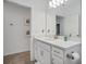 Simple bathroom with single vanity, white cabinets and a large mirror at 1352 Sunset Preserve Way, Port Charlotte, FL 33953