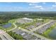 Community overview with houses, a park, and a pond at 1352 Sunset Preserve Way, Port Charlotte, FL 33953