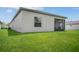 Back of house showing screened patio and grassy backyard at 1352 Sunset Preserve Way, Port Charlotte, FL 33953