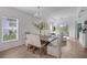Bright dining room features a wood table with seating for six and wood-look tile floors at 1352 Sunset Preserve Way, Port Charlotte, FL 33953