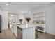 Modern kitchen with white cabinets, stainless steel appliances, and an island with seating at 1352 Sunset Preserve Way, Port Charlotte, FL 33953