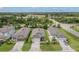 Three-house view with paved driveways and landscaping at 1352 Sunset Preserve Way, Port Charlotte, FL 33953