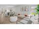 Open living room and dining area with neutral colors and hardwood flooring at 1352 Sunset Preserve Way, Port Charlotte, FL 33953