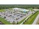 Aerial view of community center with large parking lot and playground at 1352 Sunset Preserve Way, Port Charlotte, FL 33953