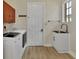 Bright laundry room with utility sink and modern appliances at 3533 Pennyroyal Rd, Port Charlotte, FL 33953