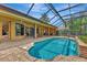 Inviting pool area with a spa and covered lanai at 3533 Pennyroyal Rd, Port Charlotte, FL 33953