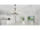 Open and bright dining room with pool view and kitchen access at 9982 Beachwalk Dr, Englewood, FL 34223