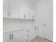 Laundry room with white cabinets and countertop at 9982 Beachwalk Dr, Englewood, FL 34223
