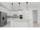 Open concept kitchen with island, stainless steel appliances, and pool view at 9982 Beachwalk Dr, Englewood, FL 34223