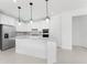 Modern kitchen with white cabinets, stainless steel appliances, and an island at 9982 Beachwalk Dr, Englewood, FL 34223