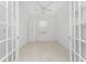 Spacious office with French doors and a ceiling fan at 9982 Beachwalk Dr, Englewood, FL 34223