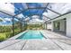 Relaxing screened pool and patio with garden views at 9982 Beachwalk Dr, Englewood, FL 34223