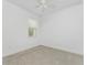 Simple bedroom with window and ceiling fan at 9982 Beachwalk Dr, Englewood, FL 34223