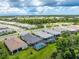 Aerial view of houses with pools in a residential community at 9982 Beachwalk Dr, Englewood, FL 34223