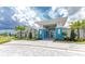 Exterior view of a community center with palm trees at 9982 Beachwalk Dr, Englewood, FL 34223