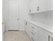 Laundry room with white cabinets and countertop space at 9982 Beachwalk Dr, Englewood, FL 34223