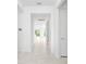 Clean hallway with tile floors leading to the living area at 9982 Beachwalk Dr, Englewood, FL 34223