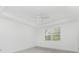 Bright bedroom with ceiling fan and window at 9982 Beachwalk Dr, Englewood, FL 34223