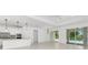 Spacious dining room with pool view and modern chandelier at 9982 Beachwalk Dr, Englewood, FL 34223