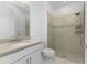 Clean bathroom featuring a walk-in shower and white vanity at 9982 Beachwalk Dr, Englewood, FL 34223