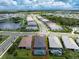 Aerial view of home community, showcasing houses with pools and lush landscaping at 9982 Beachwalk Dr, Englewood, FL 34223