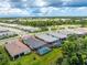 Aerial view of homes in a community, highlighting a house with a pool and screened enclosure at 9982 Beachwalk Dr, Englewood, FL 34223