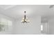 Elegant dining room with chandelier and large windows at 9982 Beachwalk Dr, Englewood, FL 34223