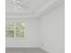 Spacious bedroom with ceiling fan and window at 9982 Beachwalk Dr, Englewood, FL 34223