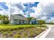Attractive community clubhouse with landscaping and welcoming entryway at 9982 Beachwalk Dr, Englewood, FL 34223