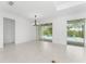 Bright dining room with pool access and modern chandelier at 9982 Beachwalk Dr, Englewood, FL 34223