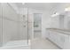 Bathroom with shower and double vanity at 9982 Beachwalk Dr, Englewood, FL 34223