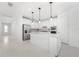 Modern kitchen with white cabinets, stainless steel appliances, and an island at 9982 Beachwalk Dr, Englewood, FL 34223