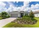 Beautiful house with a landscaped yard and paved driveway at 9982 Beachwalk Dr, Englewood, FL 34223