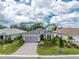 Single-Gathering home with gray roof and paver driveway at 9982 Beachwalk Dr, Englewood, FL 34223