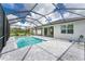 Screened pool and patio with beautiful landscaping at 9982 Beachwalk Dr, Englewood, FL 34223