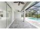 Covered patio with access to the pool and kitchen at 9982 Beachwalk Dr, Englewood, FL 34223