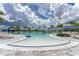 Large, resort-style pool with plenty of lounge chairs and a waterfall feature at 9982 Beachwalk Dr, Englewood, FL 34223